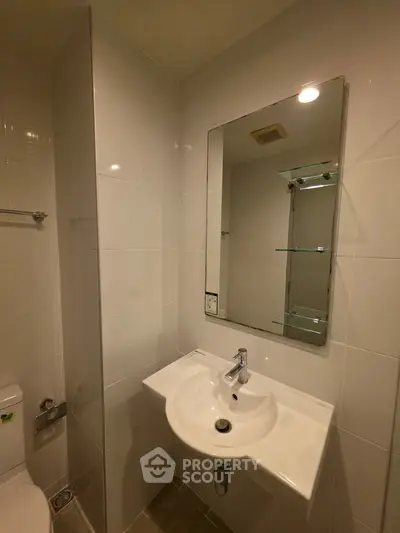 Modern bathroom with sleek white tiles and a stylish sink