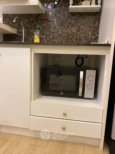 Modern kitchen with built-in microwave and stylish backsplash