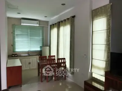 Cozy kitchen and dining area with natural light and modern furnishings