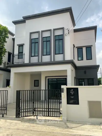 Modern two-story house with sleek design and gated entrance