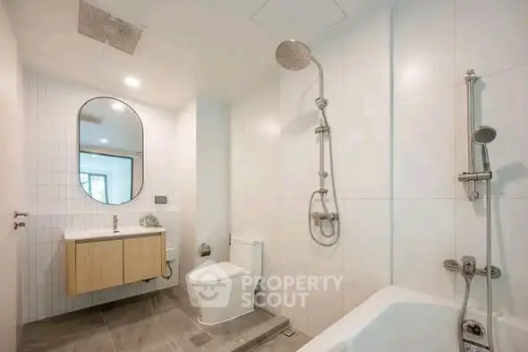 Modern bathroom with sleek fixtures and elegant design, featuring a bathtub and stylish vanity.