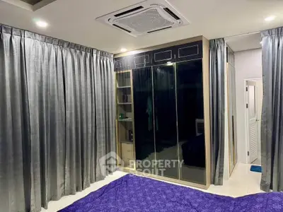 Luxurious bedroom with elegant curtains and modern wardrobe design.