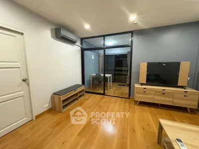 Modern living room with wooden flooring and sleek furniture