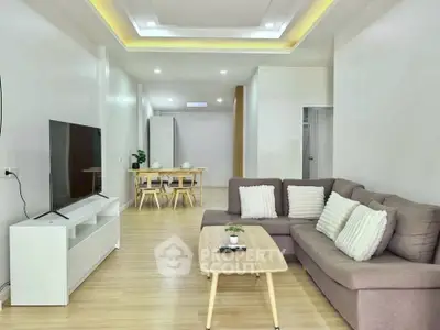 Spacious modern living room with cozy sofa and sleek TV setup