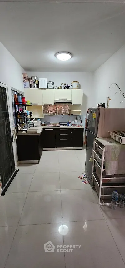 Modern kitchen with sleek cabinets and stainless steel appliances in a cozy apartment.