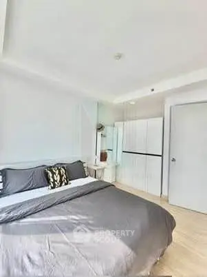 Spacious modern bedroom with stylish decor and ample natural light