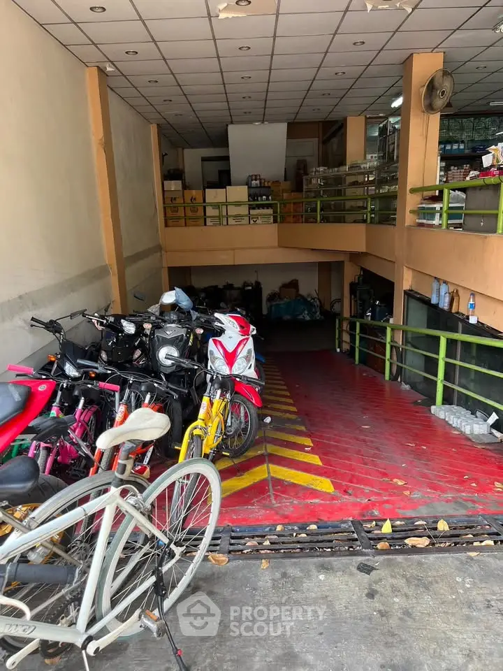 Spacious garage with multiple motorcycles and bicycles, featuring a mezzanine storage area.