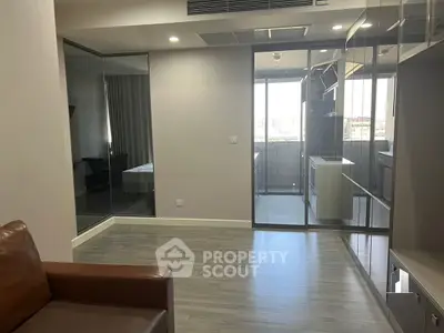 Modern apartment interior with glass walls and balcony view