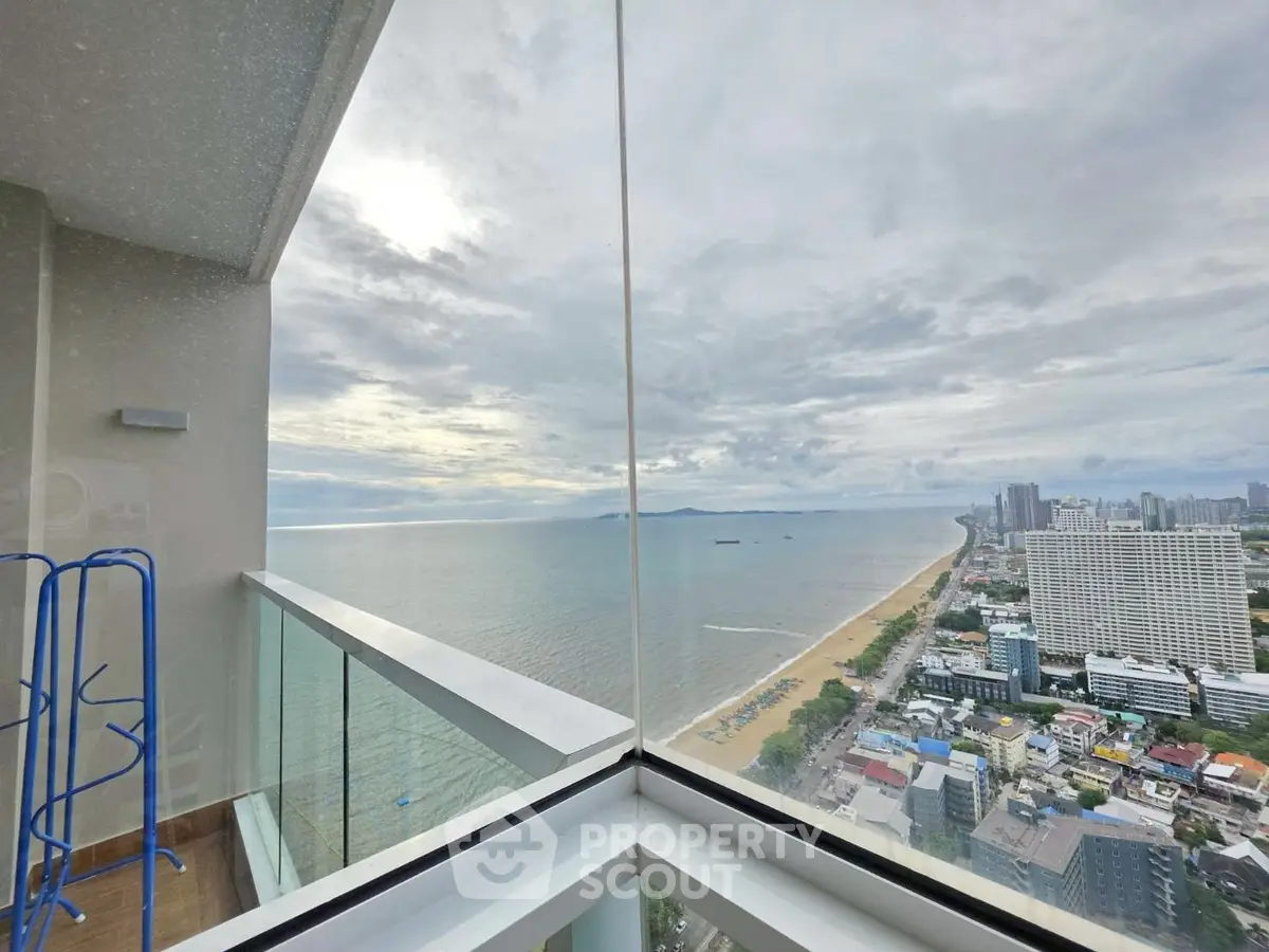 Stunning ocean view from high-rise balcony overlooking cityscape and beach