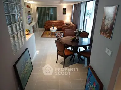 Spacious living room with elegant furniture and large windows offering natural light.