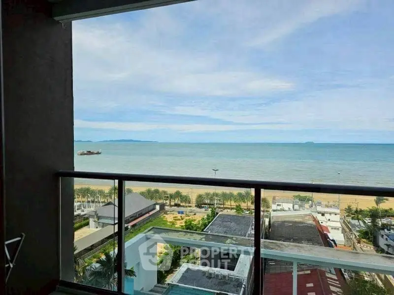 Stunning ocean view from a high-rise balcony overlooking the beach and horizon.
