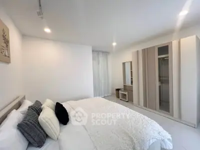 Modern minimalist bedroom with cozy bed and sleek wardrobe