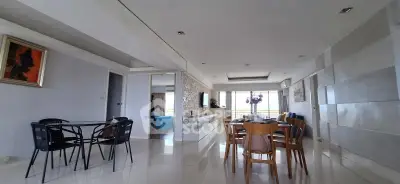 Spacious modern living and dining area with elegant decor and natural light.