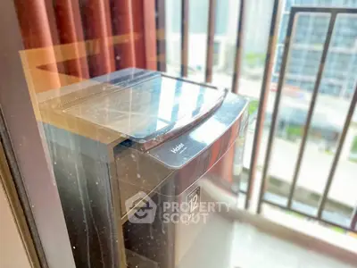 Modern balcony with washing machine and city view, perfect for urban living.