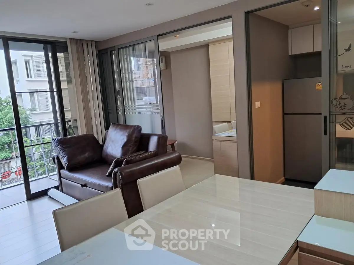 Modern living room with leather sofa and open kitchen in a stylish apartment