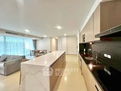 Spacious open-plan kitchen and living area with modern design and natural light.