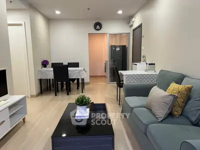 Modern living room with stylish furniture and dining area in open layout apartment.