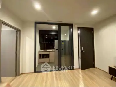 Modern apartment interior with open kitchen and sleek wooden flooring