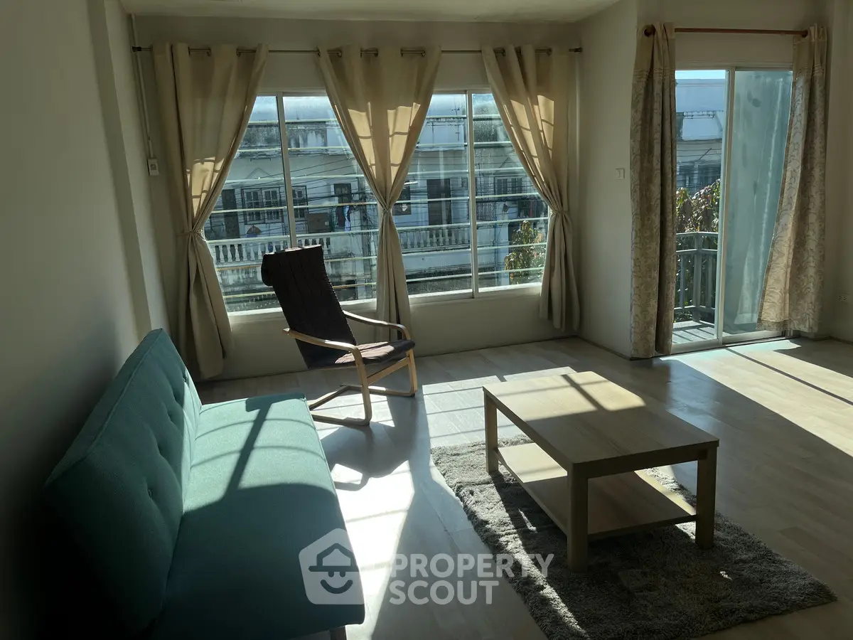 Bright living room with large windows and modern furniture