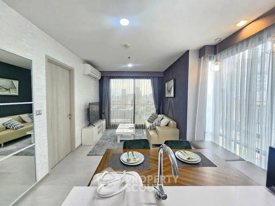Modern open-plan living room with stylish decor and city view, perfect for urban living.