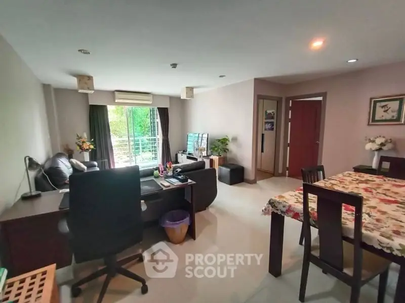 Spacious living room with modern furniture and balcony view in a stylish apartment.