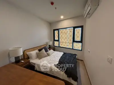 Cozy bedroom with modern decor and ample natural light