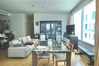 Spacious living room with modern furniture and large windows offering natural light.