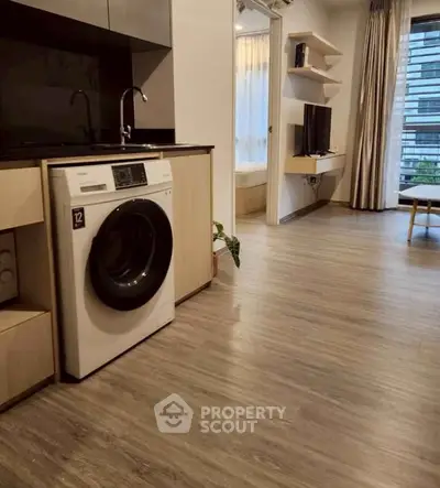 Modern apartment interior with washing machine and open living space