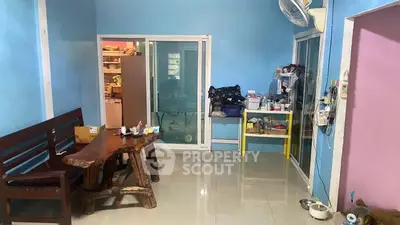 Cozy living room with rustic wooden furniture and vibrant blue walls.