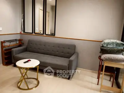 Modern living room with stylish gray sofa and elegant round coffee table