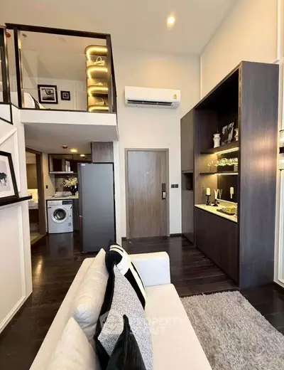 Modern loft apartment with stylish interior, featuring a cozy living area and built-in storage solutions.