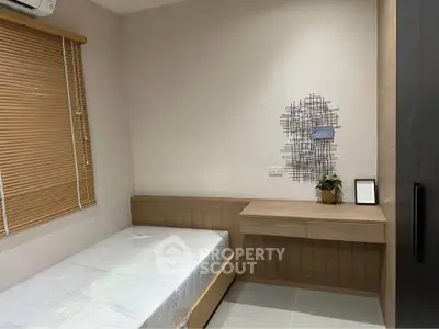 Cozy minimalist bedroom with single bed and wooden furniture