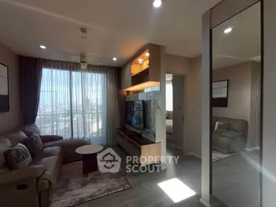 Modern living room with large windows and stylish furniture in a high-rise apartment.
