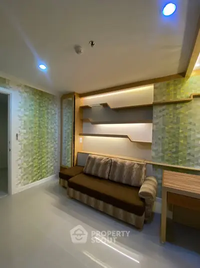 Modern living room with stylish geometric wallpaper and cozy brown sofa
