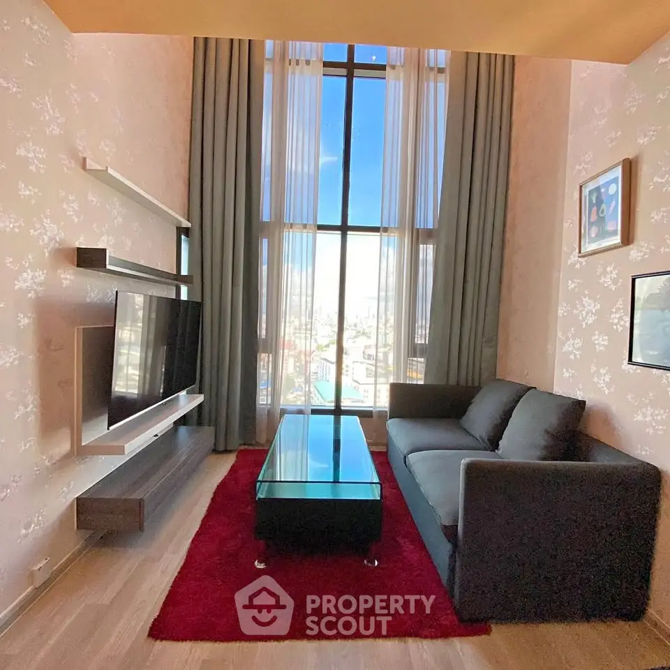 Modern living room with high ceiling and large window offering city views.