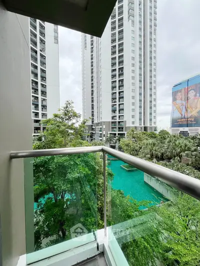 Stunning balcony view of modern high-rise buildings and lush greenery