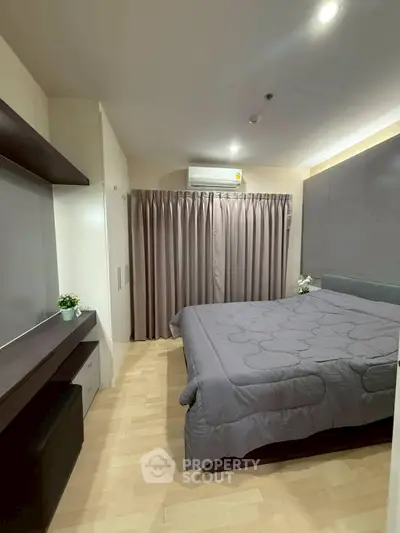 Modern bedroom with stylish decor and ample natural light, featuring a cozy bed and elegant furnishings.