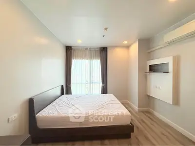 Spacious bedroom with large window and modern minimalist design