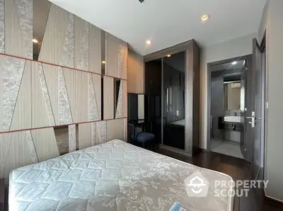 Modern bedroom with stylish wall design and ensuite bathroom