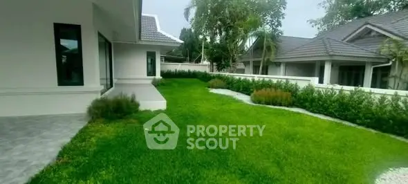 Spacious garden area with lush greenery in a modern residential property.