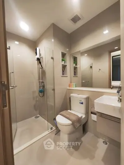Modern bathroom with glass shower and sleek fixtures