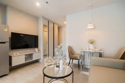 Modern living room with sleek furniture and dining area in a stylish apartment.