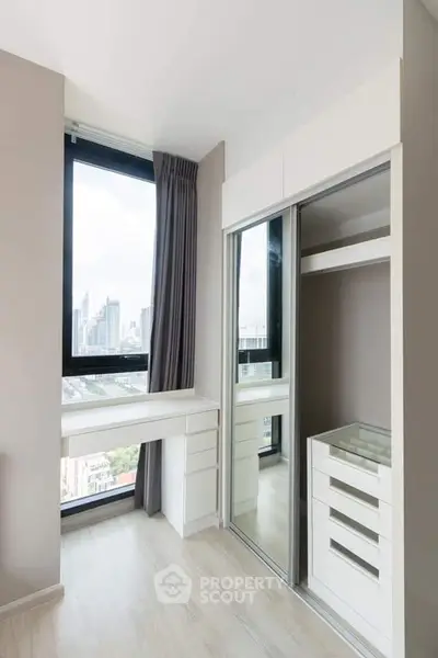 Modern bedroom with city view and built-in wardrobe