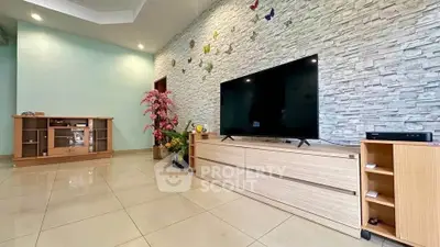 Spacious living room with modern TV setup and stylish stone accent wall.