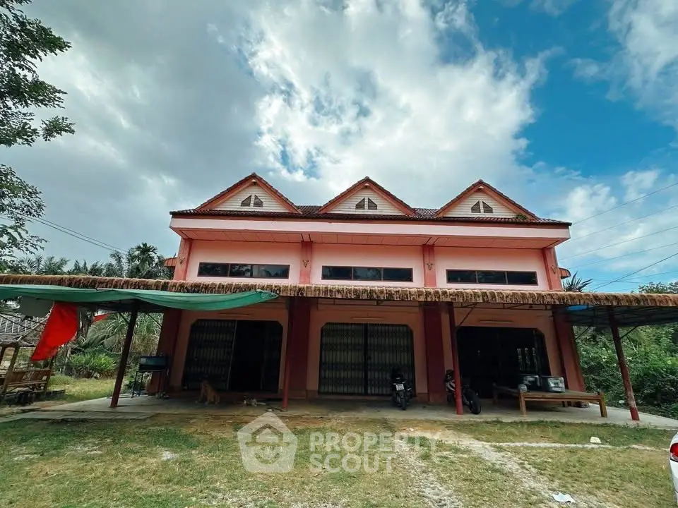Charming two-story house with unique architectural design and lush surroundings, perfect for serene living.