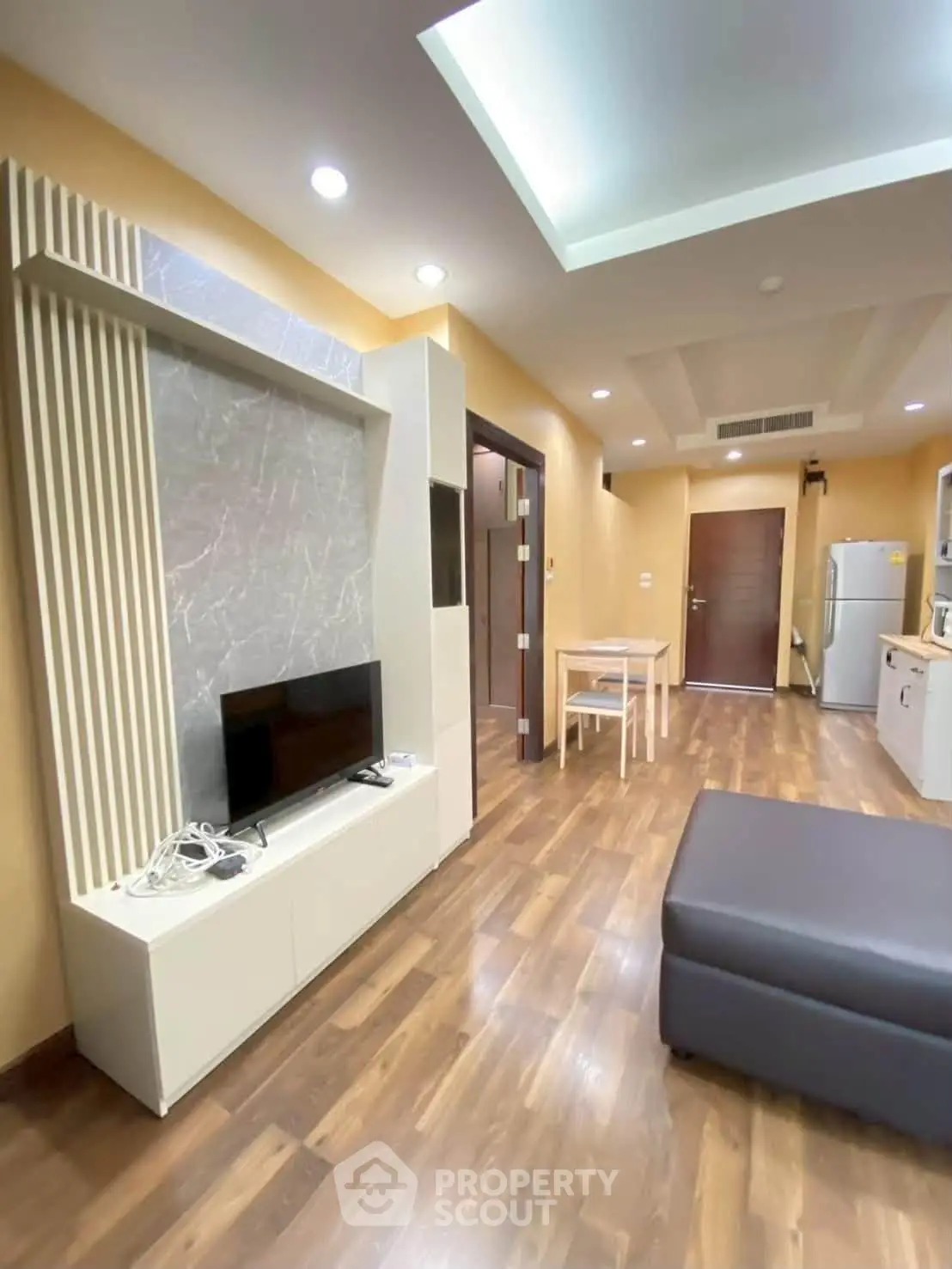 Modern living room with sleek design and open layout, featuring hardwood floors and contemporary furniture.