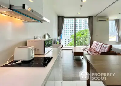 Modern open-plan kitchen and living room with city view and natural light