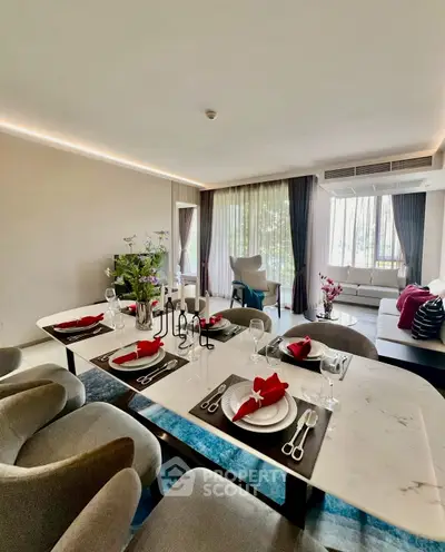 Luxurious open-plan living and dining area with elegant decor and natural light.