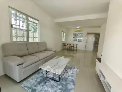 Spacious living room with modern sofa and marble coffee table in bright apartment
