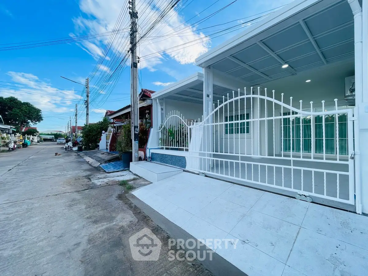 Charming modern house with gated entrance and spacious driveway in a serene neighborhood.